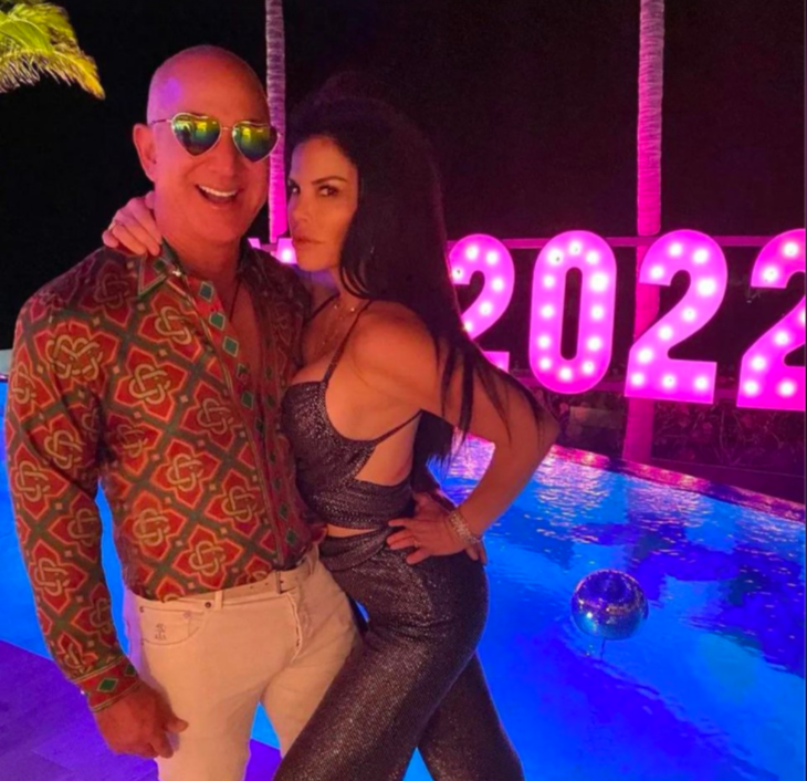 Man and woman in front of a pool and 2022 sign