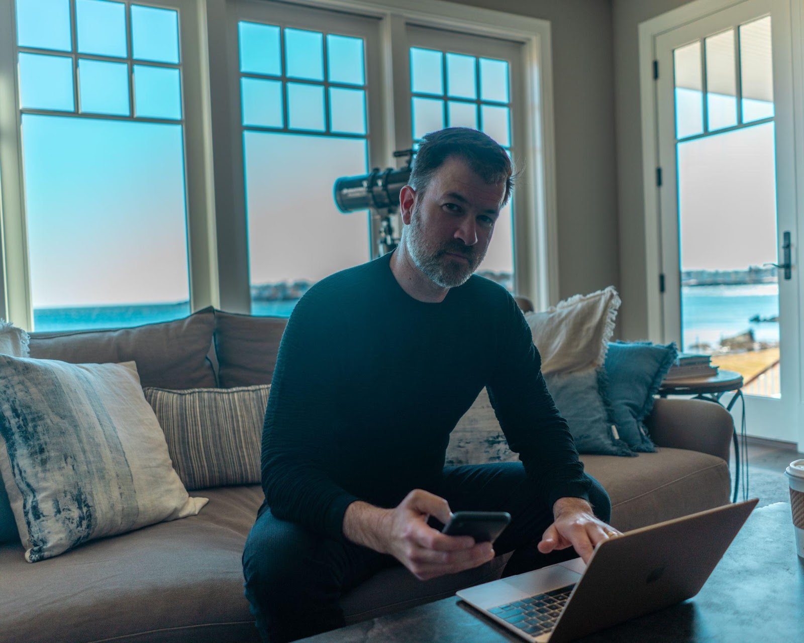 jeff sitting on a couch with his laptop