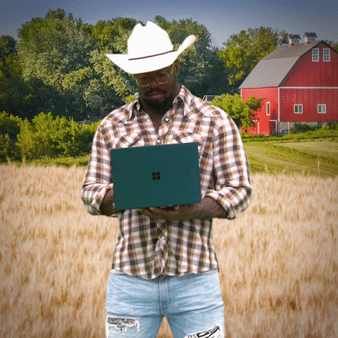 cowboy holding a laptop